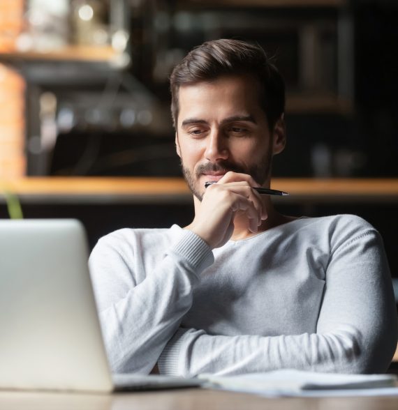 Thoughtful businessman think of online project looking at laptop Thoughtful businessman think of online project looking at laptop at workplace, dreamy professional consider solution sit at work desk with computer, student search new idea inspiration in office cafe